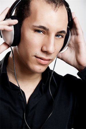 Portrait of a young man listening music with headphones Stock Photo - Budget Royalty-Free & Subscription, Code: 400-04215844
