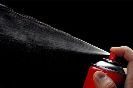 Close-up of red aerosol can showing off the spray against black background Photographie de stock - Aubaine LD & Abonnement, Code: 400-04215878