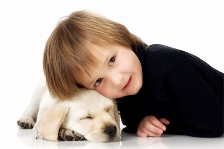 simsearch:400-06758392,k - Child lying with head on sleeping Labrador retriever puppy Photographie de stock - Aubaine LD & Abonnement, Code: 400-04215898