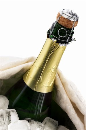 Close-up of a cold bottle of champagne on ice with white background Stock Photo - Budget Royalty-Free & Subscription, Code: 400-04215964