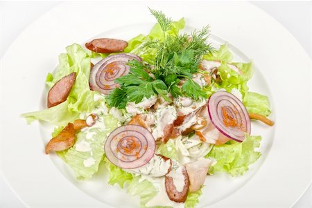 simsearch:400-04839538,k - Tasty salad dish close up with sausage and vegetables on a white background Photographie de stock - Aubaine LD & Abonnement, Code: 400-04216954