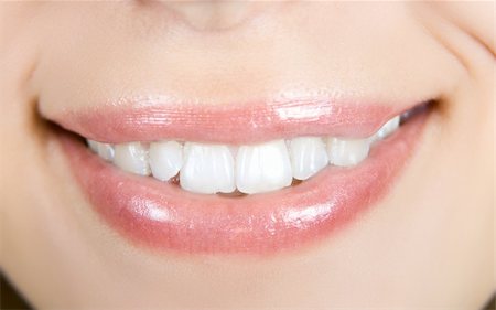 simsearch:400-04287911,k - Smiling woman mouth with white teeth closeup Photographie de stock - Aubaine LD & Abonnement, Code: 400-04216962