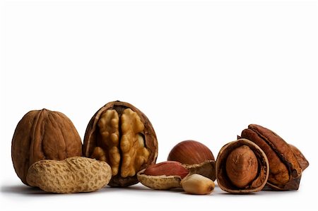 peanut object - cracked and closed pecans walnuts hazelnuts and peanuts on white background Foto de stock - Super Valor sin royalties y Suscripción, Código: 400-04217033