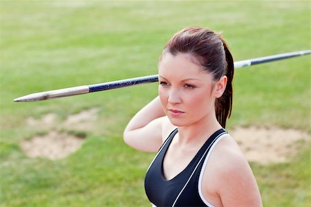 Determined female athlete ready to throw javelin in a stadium Stock Photo - Budget Royalty-Free & Subscription, Code: 400-04217234