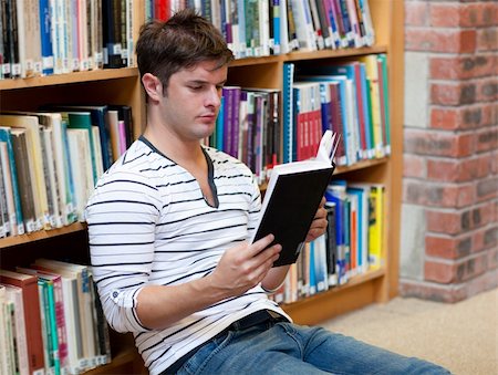 simsearch:400-04295114,k - Handsome young man reading a book stting on the floor in a bookstore Photographie de stock - Aubaine LD & Abonnement, Code: 400-04217240