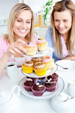 simsearch:400-04729451,k - Positive young women eating cakes in the kitchen at home Stock Photo - Budget Royalty-Free & Subscription, Code: 400-04217589