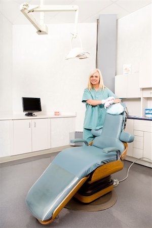 A happy assistant / hygienist standing by a dental chair Stock Photo - Budget Royalty-Free & Subscription, Code: 400-04218077