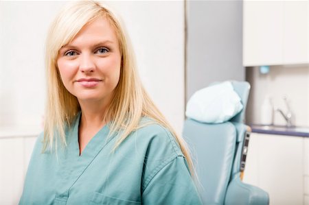 A portrait of a dental hygienist in front of a dental chair Stock Photo - Budget Royalty-Free & Subscription, Code: 400-04218079