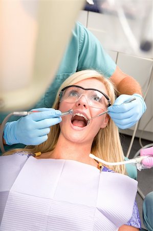 dentist drill - A patient at the dentist having their teeth worked on Stock Photo - Budget Royalty-Free & Subscription, Code: 400-04218091