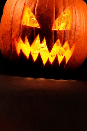 simsearch:400-07793717,k - Heavy contrast photo of a carved evil pumpkin glowing.  Pulp and seeds still inside. Photographie de stock - Aubaine LD & Abonnement, Code: 400-04218182