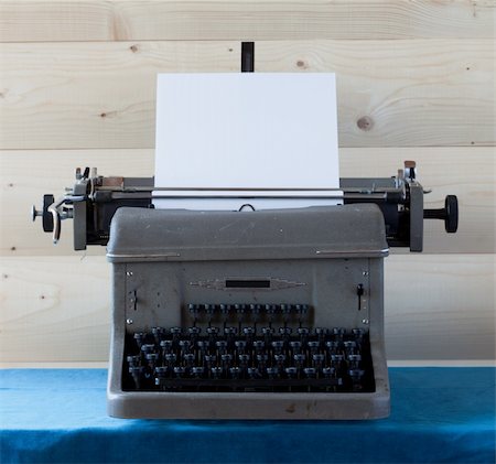 The old typewriter with a sheet of paper against a wooden wall Stock Photo - Budget Royalty-Free & Subscription, Code: 400-04218556