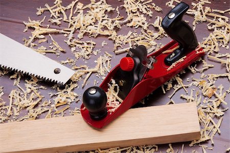 Red plane, wooden brick, handsaw and shavings Stock Photo - Budget Royalty-Free & Subscription, Code: 400-04219000