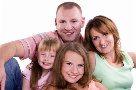 Happy family. Mother, father and two daughter are smiling . Woman, man and girls are lying on the floor and posing happily. Foto de stock - Super Valor sin royalties y Suscripción, Código: 400-04219131