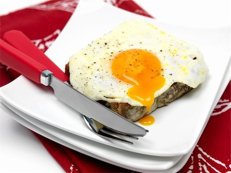 A freshly fried egg on a piece of toast Stock Photo - Budget Royalty-Free & Subscription, Code: 400-04219537