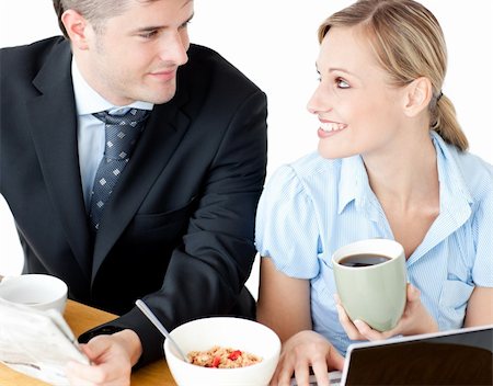 simsearch:400-05741872,k - Affectionate young couple having breakfast using their laptop at home Stock Photo - Budget Royalty-Free & Subscription, Code: 400-04210045