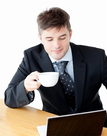 simsearch:400-05737647,k - Charismatic businesman drinking coffee using his laptop at the breakfast table Stock Photo - Budget Royalty-Free & Subscription, Code: 400-04210043