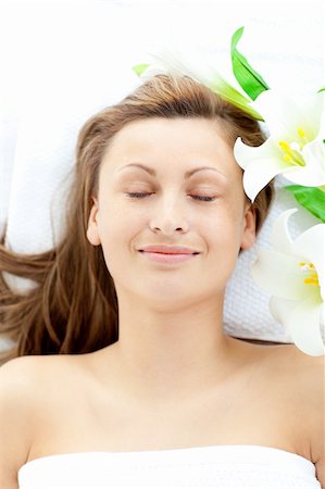 simsearch:400-04044944,k - Positive young woman lying on a massage table in a spa center Stock Photo - Budget Royalty-Free & Subscription, Code: 400-04210120