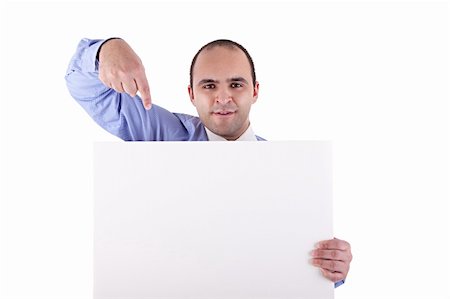 employee hold a sign - Young businessman holding a whiteboard and pointing, looking at the camera, isolated on white, studio shot Stock Photo - Budget Royalty-Free & Subscription, Code: 400-04210186
