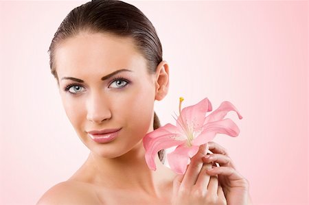 simsearch:400-06096871,k - Fresh clear healthy portrait of young woman with pink lily and stunning blue eyes Stock Photo - Budget Royalty-Free & Subscription, Code: 400-04210466