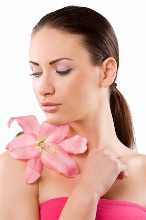 simsearch:400-06137895,k - Fresh clear healthy skin on the face of beautiful woman over white background with a pink lily flower on her shoulder Foto de stock - Super Valor sin royalties y Suscripción, Código: 400-04210461