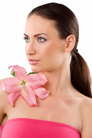 simsearch:400-04323317,k - graceful brunette with pink lily looking on one side with her stunning eyes Stock Photo - Budget Royalty-Free & Subscription, Code: 400-04210463