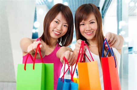 simsearch:400-06092781,k - Happy Asian girls standing with shopping bags, shopping mall as background. Photographie de stock - Aubaine LD & Abonnement, Code: 400-04210503