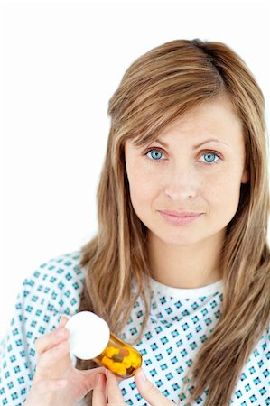 simsearch:400-05892402,k - portrait of a female patient holding pills looking at the camera against a white background Stock Photo - Budget Royalty-Free & Subscription, Code: 400-04210560
