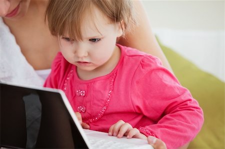 simsearch:400-04712944,k - Close-up of a facinated girl using a laptop with her mother at home Stock Photo - Budget Royalty-Free & Subscription, Code: 400-04210822