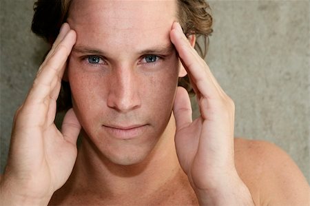 Young man with headache and holding his temples Stock Photo - Budget Royalty-Free & Subscription, Code: 400-04210893