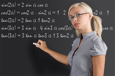 simsearch:400-05755412,k - pretty young teacher with blond hair and glasses taking a math lesson on the blackboard Photographie de stock - Aubaine LD & Abonnement, Code: 400-04210902