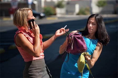 simsearch:400-04717565,k - Two friends juggle multiple tasks on city street. Stock Photo - Budget Royalty-Free & Subscription, Code: 400-04211100
