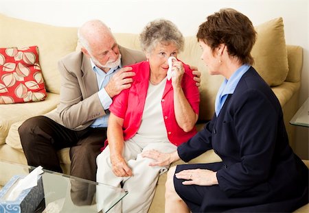 Senior couple sees a therapist to cope with grief.  Could also be funeral director meeting with clients. Fotografie stock - Microstock e Abbonamento, Codice: 400-04211239