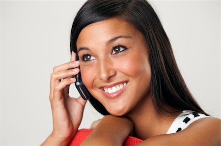 edbockstock (artist) - Attractive young Asian woman smiles while holding a mobile phone to her ear. Horizontal shot. Photographie de stock - Aubaine LD & Abonnement, Code: 400-04211615