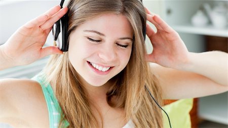 folk house - Young woman listening to music with headphones at home Stock Photo - Budget Royalty-Free & Subscription, Code: 400-04211799