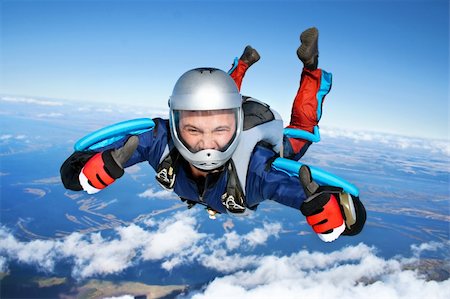 skydiver - Skydiver falls through the air. All right! Thumbs up! Parachuting is fun! Stock Photo - Budget Royalty-Free & Subscription, Code: 400-04212234