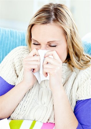 simsearch:400-04190823,k - Diseased woman lying on a sofa with tissues and blowing against a white background Foto de stock - Super Valor sin royalties y Suscripción, Código: 400-04212330