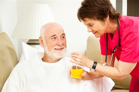 Home nurse giving her elderly patient a glass of orange juice. Stock Photo - Budget Royalty-Free & Subscription, Code: 400-04212487