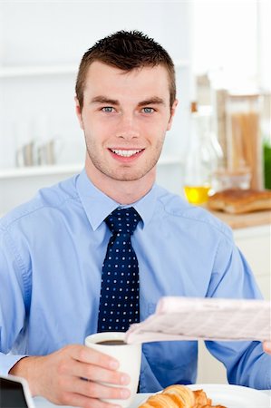 simsearch:400-05749531,k - Happy businessman reading the newspaper drinking coffee in the morning at home in the kitchen Stock Photo - Budget Royalty-Free & Subscription, Code: 400-04212839