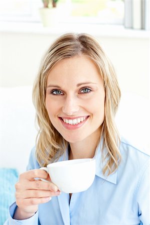 simsearch:400-04341796,k - Captivating businesswoman holding a cup sitting on a sofa at home Stockbilder - Microstock & Abonnement, Bildnummer: 400-04212868