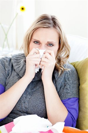 simsearch:400-04212905,k - Sick woman using a tissue sitting on a sofa at home Stock Photo - Budget Royalty-Free & Subscription, Code: 400-04212873