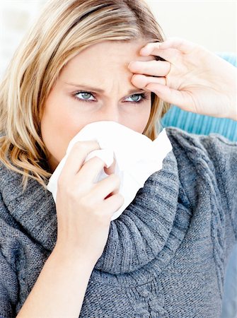 simsearch:400-04212905,k - Dejected woman using a tissue sitting on a sofa at home Stock Photo - Budget Royalty-Free & Subscription, Code: 400-04212891