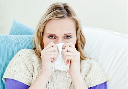 simsearch:400-04201129,k - Diseased woman using a tissue sitting on a sofa at home Stock Photo - Budget Royalty-Free & Subscription, Code: 400-04212907