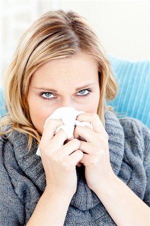 simsearch:400-04201129,k - Sick woman using a tissue sitting on a sofa at home Stock Photo - Budget Royalty-Free & Subscription, Code: 400-04212910