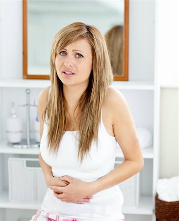 Blond woman having a stomachache in her bathroom at home Stock Photo - Budget Royalty-Free & Subscription, Code: 400-04213014
