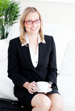 simsearch:400-05741872,k - confident business woman with glasses drinking coffee at home sitting in the sofa Foto de stock - Super Valor sin royalties y Suscripción, Código: 400-04213087