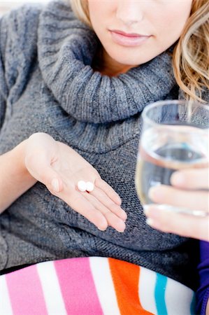 simsearch:400-04212905,k - Close-up of an ill woman holding pills and water in the living room Stock Photo - Budget Royalty-Free & Subscription, Code: 400-04213092