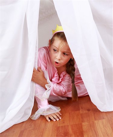 Adorable girl dressed as princess playing hide-and-seek at home Stock Photo - Budget Royalty-Free & Subscription, Code: 400-04213120