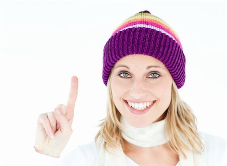 simsearch:400-06132090,k - cheerful woman with a cap showing the top and smiling at the camera against a white background Photographie de stock - Aubaine LD & Abonnement, Code: 400-04213151