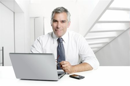 simsearch:400-04204942,k - businessman senior gray hair working laptop interior modern white office Stock Photo - Budget Royalty-Free & Subscription, Code: 400-04213788