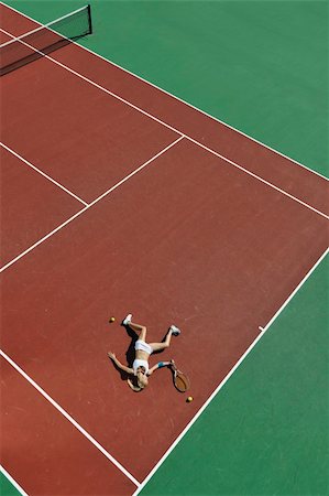 simsearch:400-06061549,k - young fit woman play tennis outdoor on orange tennis field at early morning Photographie de stock - Aubaine LD & Abonnement, Code: 400-04224356